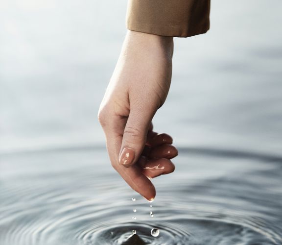 Photo: Hand touches the water surface